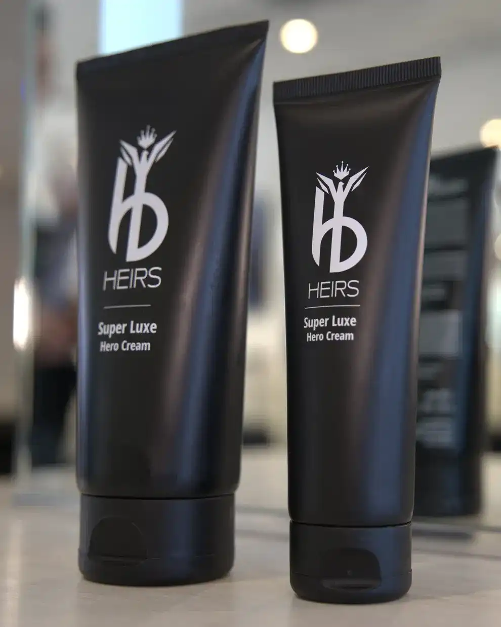 Heirs Super Luxe Hero Cream tubes on a counter.